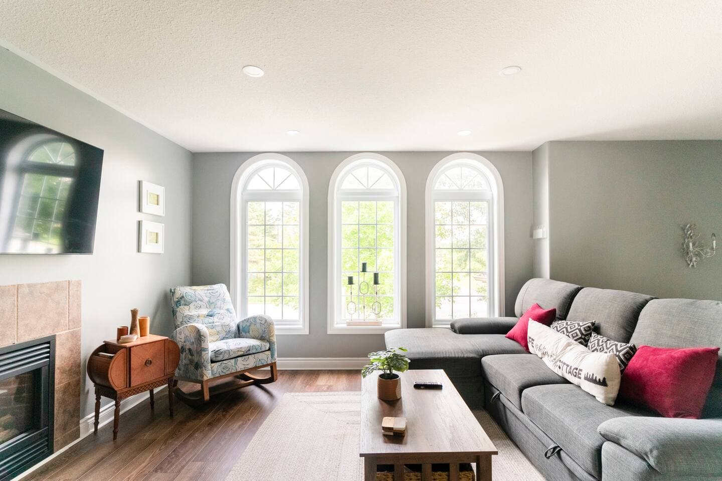 Bright living room with arched windows and a fireplace